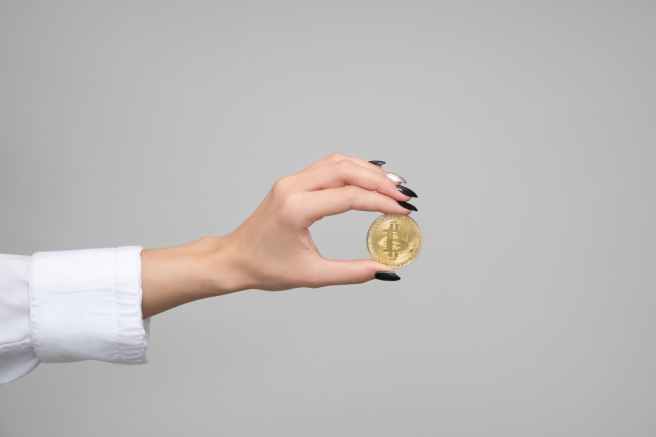 woman holding a bitcoin